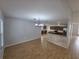 Open living area showcasing wood-look tile flooring and a view into the modern kitchen at 13551 Banner Rd, Spring Hill, FL 34609