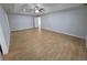 Open living space with wood-look tile flooring and neutral wall color; ready for your personal touch! at 13551 Banner Rd, Spring Hill, FL 34609