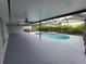 Relaxing screened-in pool area with patio and fan at 13551 Banner Rd, Spring Hill, FL 34609