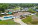 An aerial view of a ranch-style house, showcasing a large fenced in backyard with a sparkling blue in-ground pool at 1410 Moss Laden Ct, Brandon, FL 33511