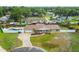 Aerial view of a ranch-style home featuring a fenced backyard with an in-ground pool and a driveway leading to the garage at 1410 Moss Laden Ct, Brandon, FL 33511