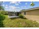 The backyard is large and lush, complemented by a screened-in porch that offers a cozy and bug-free outdoor space at 1410 Moss Laden Ct, Brandon, FL 33511