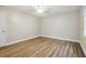 Bright bedroom features wood-look flooring and a ceiling fan for added comfort at 1410 Moss Laden Ct, Brandon, FL 33511