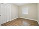 Bedroom featuring closet, window, neutral walls, wood-look floors at 1410 Moss Laden Ct, Brandon, FL 33511