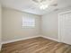 Bedroom featuring modern ceiling fan, neutral walls, wood-look floors, and a closet at 1410 Moss Laden Ct, Brandon, FL 33511