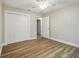 Bedroom features a large closet, wood-look flooring, and neutral wall paint at 1410 Moss Laden Ct, Brandon, FL 33511