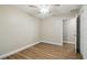 Bedroom featuring modern ceiling fan, neutral walls, wood-look floors, and a closet at 1410 Moss Laden Ct, Brandon, FL 33511