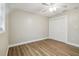 Bedroom with neutral walls, wood-look floors, closet and bright natural light from the window at 1410 Moss Laden Ct, Brandon, FL 33511