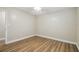 This bedroom features wood-look flooring and a ceiling fan with lights at 1410 Moss Laden Ct, Brandon, FL 33511