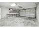A well-lit and organized garage with a workbench, storage shelves, and a garage door offers convenience and functionality at 1410 Moss Laden Ct, Brandon, FL 33511