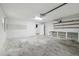 Spacious garage with ample storage, a workbench, and an open layout provides a versatile space for hobbies and projects at 1410 Moss Laden Ct, Brandon, FL 33511