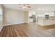 Open-concept kitchen and living space with stainless steel appliances and bright white cabinets at 1410 Moss Laden Ct, Brandon, FL 33511