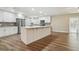 Modern kitchen with stainless appliances, white cabinets, decorative backsplash, and island at 1410 Moss Laden Ct, Brandon, FL 33511