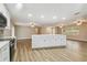 Open floorplan with a large kitchen island, modern lighting, and wood-style flooring at 1410 Moss Laden Ct, Brandon, FL 33511