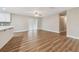 A living room with wood-look flooring, neutral walls, and a ceiling fan at 1410 Moss Laden Ct, Brandon, FL 33511