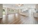 Spacious open-concept living room and kitchen area, featuring modern lighting and beautiful hardwood floors at 1410 Moss Laden Ct, Brandon, FL 33511