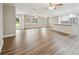 Large, open concept living room and kitchen area with updated floors, neutral paint and modern lighting at 1410 Moss Laden Ct, Brandon, FL 33511
