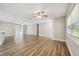 Open living space filled with light, featuring wood-look floors and access to an outdoor area at 1410 Moss Laden Ct, Brandon, FL 33511