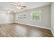 Spacious living area with two ceiling fans and multiple windows, offering natural light and an airy feel at 1410 Moss Laden Ct, Brandon, FL 33511