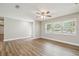 Inviting living room with new floors, neutral walls, and bright window with view of lush landscaping at 1410 Moss Laden Ct, Brandon, FL 33511