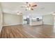Spacious open-concept area featuring an updated kitchen with a breakfast bar, neutral paint and modern lighting at 1410 Moss Laden Ct, Brandon, FL 33511