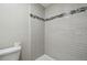 Tiled shower with accent stripe and updated fixtures at 1410 Moss Laden Ct, Brandon, FL 33511