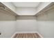 Spacious walk-in closet with wood-look flooring and ample shelving for storage at 1410 Moss Laden Ct, Brandon, FL 33511
