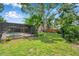 Backyard view with screened-in pool, lush greenery and landscaping, offering a serene and private outdoor living experience at 1695 Cinnamon Ln, Dunedin, FL 34698