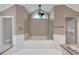 Bathroom with a large soaking tub underneath an arched window at 1695 Cinnamon Ln, Dunedin, FL 34698