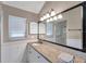 Bathroom with granite countertops, vanity lights, and framed mirror at 1695 Cinnamon Ln, Dunedin, FL 34698