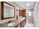 Bathroom with a double sink vanity, granite countertops, and custom cabinets at 1695 Cinnamon Ln, Dunedin, FL 34698