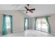 Well-lit bedroom with a ceiling fan and a sliding glass door that leads to the outside at 1695 Cinnamon Ln, Dunedin, FL 34698