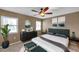 Cozy bedroom featuring a ceiling fan, and two windows with a large, plush bed at 1695 Cinnamon Ln, Dunedin, FL 34698