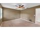 Spacious bedroom featuring neutral walls, ceiling fan, and ample natural light at 1695 Cinnamon Ln, Dunedin, FL 34698