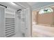 Well-organized walk-in closet adjacent to the bathroom with built-in shelving and drawers at 1695 Cinnamon Ln, Dunedin, FL 34698