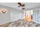 Bright dining room featuring wood look tile floor, a ceiling fan, and french doors leading to another room at 1695 Cinnamon Ln, Dunedin, FL 34698