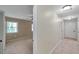 Hallway leading to bedroom with tiled floors, neutral walls, and natural light at 1695 Cinnamon Ln, Dunedin, FL 34698