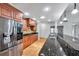 Well-appointed kitchen with stainless steel appliances, granite countertops, and custom wood cabinets at 1695 Cinnamon Ln, Dunedin, FL 34698
