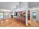 Open kitchen featuring an island, granite countertops, hardwood floors, and modern appliances at 1695 Cinnamon Ln, Dunedin, FL 34698
