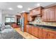 Modern kitchen featuring granite countertops, stainless steel appliances, and custom cabinetry at 1695 Cinnamon Ln, Dunedin, FL 34698
