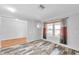 Bright room with wood-look floors, neutral paint, and a large window bringing in natural light, perfect for a home office at 1695 Cinnamon Ln, Dunedin, FL 34698