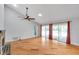 Open-concept living room featuring hardwood floors and sliding glass doors leading to a patio at 1695 Cinnamon Ln, Dunedin, FL 34698