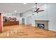 Open concept living space with a fireplace, hardwood floors, and easy access to the kitchen area at 1695 Cinnamon Ln, Dunedin, FL 34698