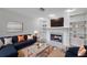 Stylish living room boasts a cozy fireplace, built-in shelves, and comfortable seating, perfect for relaxation and entertaining at 1695 Cinnamon Ln, Dunedin, FL 34698
