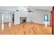Bright living room with hardwood floors, a brick fireplace, and ample natural light at 1695 Cinnamon Ln, Dunedin, FL 34698