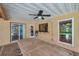 Covered brick patio area features ceiling fan and access to the house and backyard at 1695 Cinnamon Ln, Dunedin, FL 34698