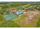 Aerial view of the community amenities, tennis courts, pool, sand volleyball court and picnic area at 17527 Stinchar Dr, Land O Lakes, FL 34638
