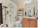 Bathroom featuring a shower, white floral curtain, granite countertop and plenty of storage at 17527 Stinchar Dr, Land O Lakes, FL 34638
