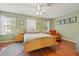 Spacious bedroom with wood floors and a ceiling fan at 17527 Stinchar Dr, Land O Lakes, FL 34638
