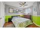 Stylish bedroom with gray walls, bright green accents, and wood floors at 17527 Stinchar Dr, Land O Lakes, FL 34638